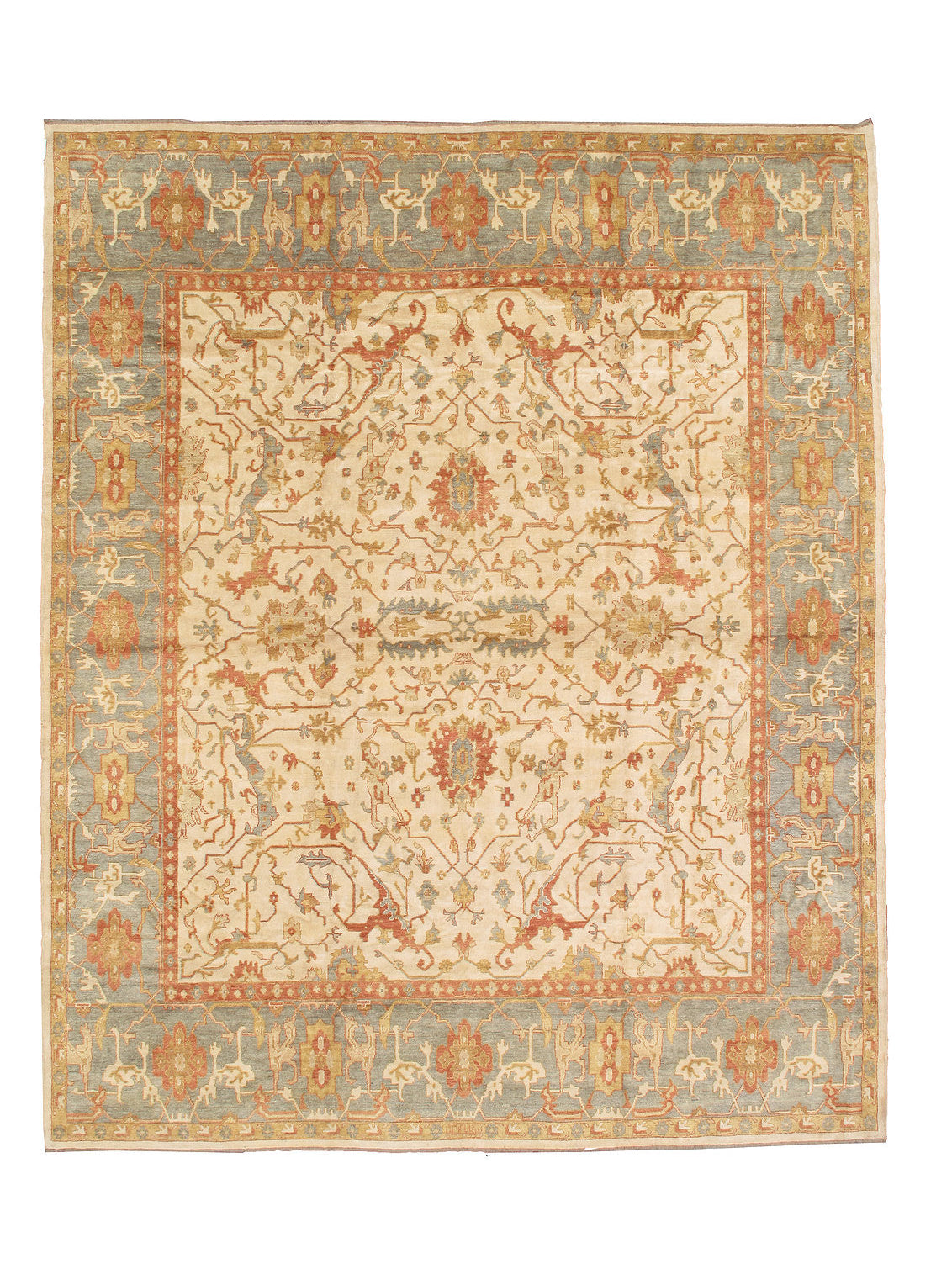 An antique-style oriental rug with a cream center field, a muted blue-gray border, and warm rust-orange and beige details throughout its intricate floral and geometric pattern.
